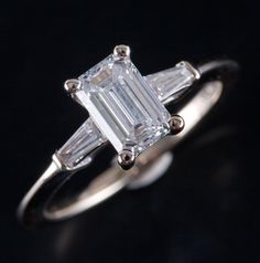 an emerald cut diamond ring with baguettes on the sides