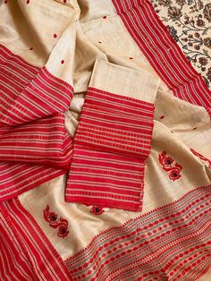 This is a creation of the master weavers of Bengal , Fulia . This saree is made of pure gachhi by gachhi  tussar and the border snd pallu is pure silk  . Very easy to carry it . One side has broad border other narrow . The colour has an  unique combinations .  Saree comes with a running blouse piece .  As it is entirely handmade so some irregularities is the mark of originality of handloom product.  With Silk mark certificate of India Government .  Fall and pico , tassel done and complimentary .  Note : Please leave your phone no and email id for shipping purpose. Red Cotton Silk Dupatta With Weaving Work, Puja Saree With Woven Motifs In Raw Silk, Raw Silk Saree With Woven Motifs For Puja, Slub Silk Saree With Weaving Work For Puja, Navratri Slub Silk Saree With Weaving Work, Navratri Katan Silk Saree With Woven Motifs, Unstitched Raw Silk Saree With Woven Motifs, Festivals Cotton Silk Dupatta With Woven Motifs, Motif Slub Silk Saree For Puja