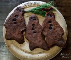 three cookies shaped like bears on a plate