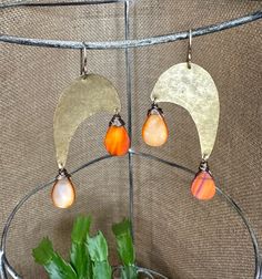 These lightly textured mod shaped brass pieces are adorned with peachy tear drop shell beads.  They are big enough to make a statement, but very lightweight.  They are hung from 14kt gold filled ear wires.  Check it out in another color  https://www.etsy.com/listing/1428173073/brass-statement-earring-mid-century?ref=listing_published_alert Each piece comes with a fabric storage bag and in a box tied with ribbon ready to gift or keep for yourself.  All packaging is recyclable and plastic free. If Bohemian Brass Teardrop Earrings With Ear Wire, Handmade Bronze Brass Teardrop Earrings, Bohemian Orange Brass Jewelry, Mod Jewelry, Gold Statement Earrings, Statement Earring, Party Earrings, Gold Earring, Fabric Storage