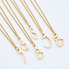 The iconic Arabic Letter has helmed Nominal for half a decade. This all new variation delivers a timeless way to represent yourself or a loved one. Your identity in one hanging letter, brought together by an elegant curb chain, meant for meaningful everyday wear. Click here to shop our matching Men's Hanging Letter Necklace. Materials & Warranty Necklace Length: 16 Inch Chain + 6 Inch Extension (22 inches total) | Extensions are available here. Material: Premium Stainless Steel, dipped in real 1 Arabic Letters, Locket Design, Hanging Letters, Donate To Charity, Necklace Women, Drawstring Pouch, Letter Necklace, Pretty Jewellery, Curb Chain