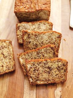 slices of banana bread sitting on top of a wooden cutting board