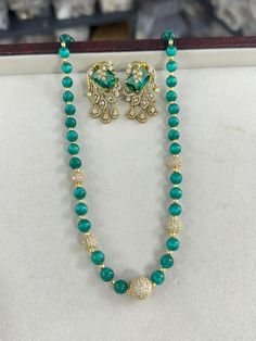 Add a touch of elegance to your jewelry collection with this stunning Emerald Bead Long Mala Necklace set, perfect for any special occasion or celebration. This exquisite piece of Indian and Pakistani jewelry features high-quality mala beads, carefully selected for their rich emerald color and lustrous shine. The necklace is adorned with sparkling Swarovski Kundan stones, creating a striking statement look. Accompanied by elegant CZ stud earrings, this set is ideal for weddings, parties, or trad Emerald Necklace With Polished Round Beads For Wedding, Elegant Beaded Chain Bridal Necklace For Festive Occasion, Elegant Emerald Necklace With Beaded Chain, Elegant Bridal Necklace With Beaded Chain For Festive Occasion, Elegant Crystal Beaded Necklace With Gemstone Beads, Elegant Festive Pearl Necklace With Beaded Chain, Elegant Crystal Faceted Beads, Elegant Faceted Crystal Beads, Festive Elegant Beaded Necklaces