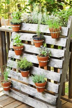 a wooden pallet filled with potted plants