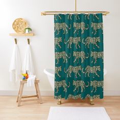 a shower curtain with leopards and giraffes on it in a bathroom