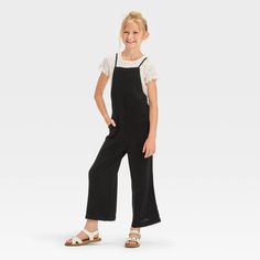 Your child will be ready for a day of sunshine and smiles in this Sleeveless Jumpsuit from Cat & Jack™. With a rayon-linen construction, sleeveless design with adjustable straps and cropped length, this poplin jumpsuit is perfect for summer fun. The pull-on style allows ease of wear, while the solid color, square neck and functional patch pockets elevate the overall look. Cat & Jack™: Designed for all children so you can trust it's made for yours. Fabric Tape, Kids Outfits Girls, Hem Style, Black Xs, Woven Top, Sleeveless Jumpsuits, Fabric Squares, Pair Of Pants, Dress Romper