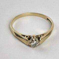 a gold ring with a diamond in the middle