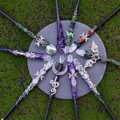 a circular arrangement of different colored and shaped objects on top of a green surface with grass