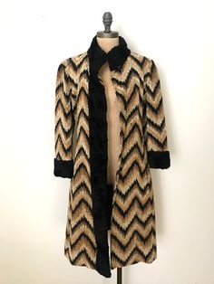 "Stunning and truly one-of-a-kind tapestry coat. This beautiful coat is from the 60's and is in impeccable shape. The details are like none-other, each chevron stripe matches at the seams and is a sign of true craftsmanship. The collar and cuffs are made of faux fur and line the center front to cover the snaps. | Details | Modern Size: Small Materials: Chenille Condition: Excellent vintage condition | Measurements | all measurements are taken while laying flat Shoulders: 17 inches Bust: 17 inche Vintage Long Coat For Party, Vintage White Lace Dress, Tapestry Coat, 1960s Coat, Vintage Crochet Dresses, 1950s Cocktail Dress, Black Pleated Dress, Lace Dress Vintage, 1980s Dresses