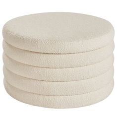 six white round cushions stacked on top of each other in front of a white background