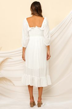 We're dreaming of magical moments wandering the streets of Venice in our Loved By The Moon Midi Dress! Style yours with vintage boots and a rancher hat! Floaty midi dress. true to size Square neckline Can be worn on or off the shoulder 3/4-length sleeve Shirring along bodice Frill trimming on hem No zipper. slip-on style Partially lined Lightweight. 100% cotton Non-stretchy material Cold hand wash only Model wears XS Length from shoulder to hem: 132cm on an S Midi-length Prairie Dress For Garden Party, White Bohemian Midi Dress With Smocked Back, Cottagecore Midi Dress With Ruffles, Cottagecore Flowy Midi Dress For Garden Party, White Ruffle Hem Midi Dress For Fall, Bohemian Midi-length Prairie Dress, Cottagecore Midi Dress For Vacation, Summer Midi-length Prairie Dress For Brunch, White Cottagecore Dress For Day Out