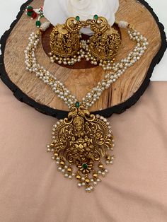 Goddess Lakshmi Matte Finish Pendent Set with Cluster Pearl Mala Gold Pendant With Pearl Mala, Gold Necklace With Lakshmi Pendant, Lakshmi Pendant Gold With Pearls, Diamond Lakshmi Pendant, Traditional Brass Temple Necklace, Luxury, Pearl Mala, Goddess Lakshmi, Social Events, Green Stone