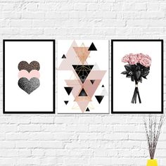 three framed art prints on a white brick wall with pink flowers and black geometric shapes