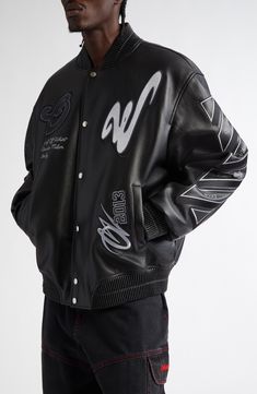 House logos and embroidered patches bring biker-inspired edge to a richly grained leather bomber jacket detailed with a tribute to Off-White's legendary founder at the sleeve. 28" length (size 50 EU) Front snap closure Blade collar Front welt pockets Ribbed cuffs and hem Lined, with 100% polyester fill Leather Made in Romania Designer Clothing Black Owned/Founded Black Leather Biker Jacket For Streetwear, Designer Varsity Jacket With Embroidered Logo For Streetwear, Luxury Varsity Jacket For Streetwear In Winter, Designer Streetwear Outerwear With Embroidered Logo, Designer Outerwear With Embroidered Logo For Streetwear, Designer Outerwear With Embroidered Logo For College, Designer Embroidered Logo Outerwear For College, Luxury Black Outerwear For College, Luxury Black Varsity Jacket For Winter