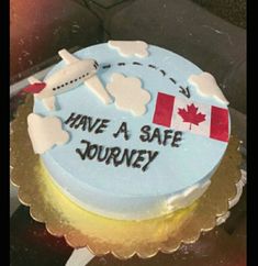 a cake that has been decorated with the words have a safe journey and an airplane on it