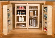 an open cabinet in the middle of a kitchen with lots of spices and condiments