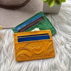 "We are a team of artisans that have worked with leather for generations, we only work with sustainable leather and we definitely love what we do. All our tooled authentic leather wallets women's are handcrafted one at a time  We ship worldwide from Hawai'i USA  IMPORTANT: If your heart is set on a specific color get it while supplies lasts!  Because all our woman wallets are handmade with sustainable leather, we do not have any specific dates to re-stock any item. This Card Holder is a beautifu Artisan Card Holder For Everyday Use, Artisan Rectangular Card Holder As Gift, Artisan Rectangular Card Holder Gift, Artisan Card Holder With Interior Slots, Artisan Handmade Card Holder For Gifts, Artisan Wallet With Interior Card Slots As Gift, Yellow Coin Purse With Card Slots As Gift, Yellow Card Holder With Card Slots As Gift, Yellow Rectangular Card Holder Gift