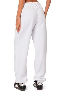 A cozy cotton blend keeps you feeling your best no matter what the day brings when you choose these oversized sweatpants. Elastic waist Side-seam pockets Elastic cuffs 50% cotton, 50% polyester Machine wash, dry flat Imported Cotton Wide Leg Joggers, Comfortable White Baggy Bottoms, White Baggy Joggers, Solid Color Baggy Sweatpants With Straight Hem, Baggy White Leisure Pants, Baggy White Pants For Leisure, White Baggy Leisure Pants, Comfortable Oversized Solid Bottoms, Casual White Wide Leg Joggers