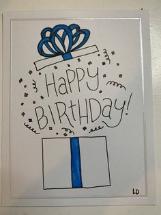 a birthday card with a blue ribbon and a gift box on it's side