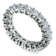 a white gold ring with five rows of round cut diamonds on the inside and outside