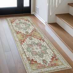 an area rug is on the floor in front of some stairs and a black door