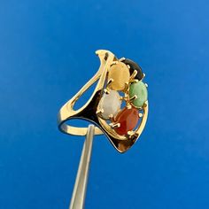 * Vintage 14K Yellow Gold Multi Gemstone Modernist Twist Cocktail Finger Ring * Ring Size: 4.0 * Top of ring measures: 1.0" x 1/2" * Height: 1/2" * Band width: 2.0 mm * Jadeite oval cabochon measures approximately 5.50 mm x 4.0 mm * Jasper oval cabochon measures approximately 5.50 mm x 4.0 mm * Agate oval cabochon measures approximately 5.50 mm x 4.0 mm * Carnelian oval cabochon measures approximately 5.50 mm x 4.0 mm * Black Onyx oval cabochon measures approximately 5.50 mm x 4.0 mm * Ring weight: 4.5 tgw * Marked: 14K * Condition: Great, as pictured. * G2485 5% Restocking Fee    Exported By ExportYourStore :) Yellow Gold Multi-stone Art Deco Jewelry, Art Deco Multi-stone Yellow Gold Jewelry, Art Deco Yellow Gold Multi-stone Jewelry, Yellow Gold Multi-stone Ruby Ring, Unique Multi-stone Ruby Ring In Yellow Gold, Multi-stone Ruby Ring In Yellow Gold, Modernist 14k Gold Ring Jewelry, Modernist 14k Gold Hallmarked Rings, Yellow Gold 14k Rings With Natural Stones