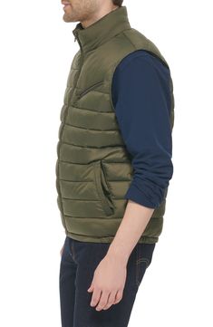 Update your cold-weather collection with this quilted puffer vest that's a versatile must-have layering piece. 26.5" length (Size M) Stand collar Sleeveless Zip front Slanted zipper chest pocket 100% nylon Machine wash cold Imported Model stats: 6'1" height, 32" waist. Model is wearing size M. Casual Cold Weather Outerwear Vest, Cold Weather Solid Puffer Vest, Solid Puffer Vest For Cold Weather, Solid Color Puffer Vest For Cold Weather, Quilted Vest For Cold Weather, Quilted Nylon Vest For Cold Weather, Casual Insulated Puffer Jacket For Cold Weather, Casual Winter Vest With Zipper Closure, Casual Sleeveless Outerwear With Padded Collar