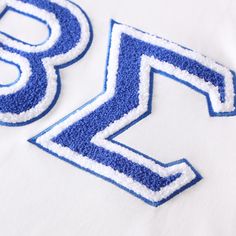 White shirt Chenille embroidered logo True to size Cotton T-shirt With Letter Embroidery For College, White Embroidered T-shirt For College, Casual Blue T-shirt With Letter Embroidery, Spring Cotton Varsity T-shirt, Blue College T-shirt With Embroidered Logo, Varsity Cotton T-shirt With Embroidered Graphics, Varsity Style Cotton Tops With Embroidered Graphics, Cotton Varsity Tops With Embroidered Graphics, White Embroidered Logo Top For College