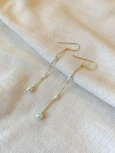 These delicate genuine pearl earrings add an elegant hint of shimmer to your special occasion look! The dainty and minimalist style is made with all sensitive skin safe materials.  * 14K Gold Filled or 925 Sterling Silver ear wire and accents * 3 inch length * Genuine Freshwater Pearls * Made with all hypoallergenic materials 🤍 ✨  Shop all Pearl earrings here!: https://etsy.me/3Xiy4c5 WHAT TO KNOW ABOUT YOUR MAGBEE JEWELRY PURCHASE: 🤍 All MagBee pieces are safe for sensitive skin and made with Cascading Pearl Earrings, Dainty Pearl Earrings, Feminine Vibes, Earrings Pearl Drop, String Earrings, Natural Pearl Earrings, Long Pearl Earrings, Hardware Jewelry, Vintage Drop Earrings