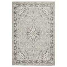 a gray rug with an ornate design on the top and bottom, in grey tones