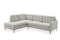 a white sectional couch sitting on top of a wooden frame