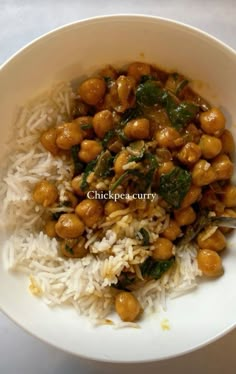 a white bowl filled with rice and chickpeas