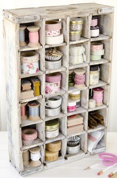 an old cabinet filled with lots of crafting supplies