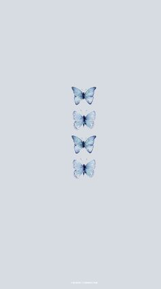 three blue butterflies flying in the sky with one on its back and another on its side