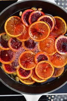 an iron skillet filled with blood orange slices