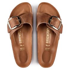 A strap, a buckle and a contoured cork footbed are masterfully combined to create the original Birkenstock sandal - the Madrid. An iconic slide with amplified buckle accent. Shown in oiled nubuck leather. Anatomically shaped cork-latex footbed Oiled leather upper, colors may vary Footbed lining: leather Sole: EVA Details: single wide strap with large adjustable metal pin buckle “Made in Germany” Material: Upper material: Oiled leather Oiled leather is one of our favourite types of leather. Its o Madrid Big Buckle, Birkenstock Madrid Big Buckle, Cognac Sandals, Birkenstock Style, Birkenstock Women, Birkenstock Sandals, Birkenstock Madrid, Zermatt, Buckle Sandals