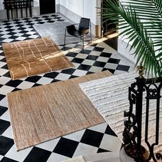 three rugs on the floor in front of a black and white checkered floor