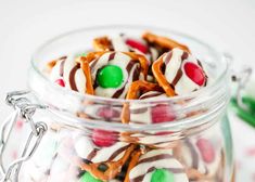 a glass jar filled with candy and pretzels