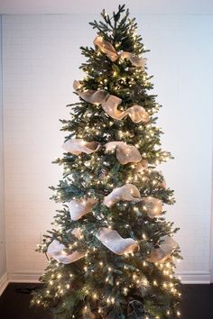 a decorated christmas tree with lights and bows