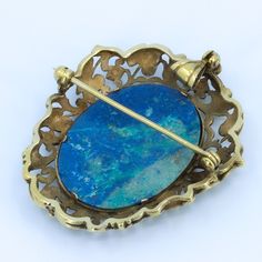 "Beautiful floral detailing in this vintage convertible brooch / pendant. Beautifully crafted 10k Gold setting with large polished lapis cabochon. Fold away bale. This piece has no markings. Chain not included - Need one? Just ask, we can help. Length of Brooch 1.80\" Length of pendant including bale 2.0\" Width of Brooch 1.54\" Lapis measurements 29.5x23 mm Weight of piece 0.48 Oz (13.62 g) CHAIN NOT INCLUDED - FOR DISPLAY ONLY This item is vintage. It has been cherished, worn, and preserved by Antique Oval Gemstone Brooch, Antique Oval Gemstone Brooches, Antique Yellow Gold Brooches With Gemstone, Antique Pendant Brooch With Cabochon, Victorian Pendant Brooches With Cabochon, Antique Oval Cabochon Brooches, Ornate Gemstone Brooches For Collectors, Antique Oval Hallmarked Brooch, Antique Pendant Brooches With Gemstone