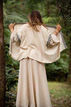 The Rumi Kimono is made with 100% cotton and features a unique, geometric border. This free flowing design is perfect for ceremonies, rituals and a touch of bohemian style. Designed to wrap around for a personal fitting of a wide range of sizes Hand made with Love ❀ Cotton Long Sleeve Kaftan For Traditional Ceremonies, Long Sleeve Cotton Kaftan For Traditional Ceremonies, Folk Style Cotton Kimono For Spring, Beige Cotton Kimono For Festivals, Bohemian Cotton Tunic Kimono, Cream Bohemian Long Sleeve Kaftan, Bohemian Cotton Kimono For Festival, Cotton Bohemian Kimono For Festival, Cotton Festival Tunic Kimono