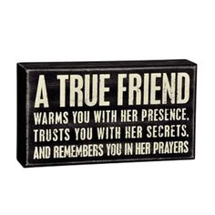 a black and white sign that says, a true friend warms you with her presence