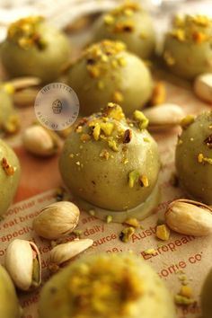 pistachio truffles with almonds and pistachio seeds on top