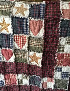 an old quilt with hearts and stars on it