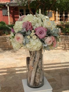 a vase filled with white and pink flowers