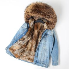 This oversize version of the classic stone washed denim jacket, thanks to metal stud and crystal decorations, celebrates this season's theme: Far West. Fox fur trimming on the opening and lining the collar. Two slit pockets and two patch ones with flap. Hook fastening. Inner lining.p>[custom tab]SHELL #1: 100% POLYESTER | SHELL #2: 100% LAMB LEATHER | LINING #1: 100% POLYESTER | RIB KNIT #1: 50% WOOL 45% ACRYLIC 5% ELASTANE | FILLING #1: 100% POLYESTER | TRIMMING #1: 100% VULPES LAGOPUS [/cus Denim Parka, Jacket Coat Fashion, Denim Jacket With Fur, Leather Coat Womens, Raccoon Dog, Real Fur Coat, Fur Parka, Rex Rabbit, Winter Parka