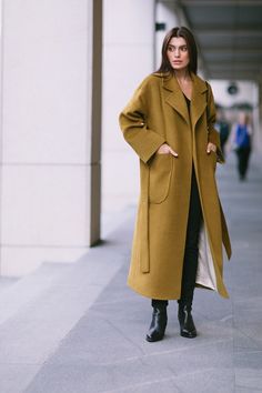 Introducing our  mustard-colored soft wool coat, a must-have addition to your fall and winter wardrobe. This coat combines style and warmth seamlessly with wrap style and oversized fit, ensuring cozy comfort in colder temperatures. With convenient patch pockets, it strikes the perfect balance between practicality and fashion-forward design. The lowered shoulders line add a modern twist, exuding a sense of casual sophistication. The belt beautifully accentuates the waist, creating an attractive and feminine silhouette that enhances your figure. Embrace the comfort and elegance of this coat, as it effortlessly blends contemporary elements with timeless style. Loose fit H-silhouette Lowered shoulders line Notch collar 2 patch pockets Belt Wool 100% Lining viscose 100% INSTRUCTIONS Dry cleanin Oversized Brown Wool Coat For Fall, Oversized Beige Wool Coat For Fall, Oversized Solid Wool Coat For Cold Weather, Camel Wool Coat For Workwear In Fall, Yellow Wool Outerwear For Winter, Oversized Long Pea Coat For Fall, Camel Wool Coat For Fall, Camel Wool Coat For Winter, Oversized Camel Winter Outerwear