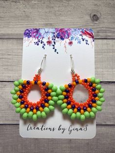 Handmade seed bead earrings. Bright and fun made with lime green, orange, yellow, and shiny purple seed beads, with a French ear wire hook. Vibrant Handmade Green Jewelry, Summer Orange Beaded Earrings With Tiny Beads, Green Teardrop Earrings With Tiny Beads, Vibrant Multicolor Beaded Earrings As Gift, Summer Orange Earrings With Tiny Beads, Vibrant Green Dangle Earrings, Vibrant Green Dangle Jewelry, Multicolor Beaded Dangle Earrings With Spacer Beads, Multicolor Dangle Beaded Earrings With Spacer Beads