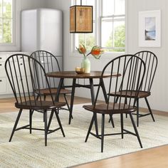 a kitchen table with four chairs around it