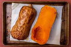 two sweet potatoes sitting on top of a pan